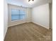 Inviting bedroom with a window and plush carpeting, perfect for relaxation and rest at 8619 Harris Lake Ln, Charlotte, NC 28269