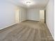 Neutral bedroom with plush carpeting, closet, and access to ensuite bathroom and hall at 8619 Harris Lake Ln, Charlotte, NC 28269