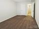 Bedroom with neutral tones, a door to the hallway, and cozy carpet flooring at 8619 Harris Lake Ln, Charlotte, NC 28269