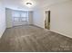 Large bedroom offering ample space and natural light through a window with blinds at 8619 Harris Lake Ln, Charlotte, NC 28269