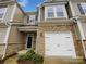 Charming townhome featuring stone accents, a one-car garage, and a welcoming front entrance at 8619 Harris Lake Ln, Charlotte, NC 28269