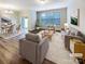 Bright living room with hardwood floors, large windows, and stylish neutral decor at 8619 Harris Lake Ln, Charlotte, NC 28269