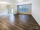 Spacious living room featuring hardwood floors and sliding door access to an outdoor space at 8619 Harris Lake Ln, Charlotte, NC 28269