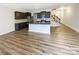 Bright open-concept living space with hardwood floors, modern kitchen, and staircase at 8619 Harris Lake Ln, Charlotte, NC 28269