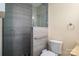 Modern bathroom featuring a glass-enclosed shower with gray tile surround, a toilet and neutral colored walls at 9026 Longview Dr, Charlotte, NC 28214