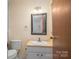 Cozy bathroom featuring a granite countertop sink and modern fixtures at 9026 Longview Dr, Charlotte, NC 28214