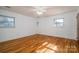 Bright bedroom with hardwood floors, ample natural light from multiple windows at 9026 Longview Dr, Charlotte, NC 28214