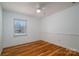 Clean bedroom with wood floors, and a well-lit window at 9026 Longview Dr, Charlotte, NC 28214