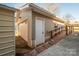 An image of a garage featuring vinyl siding, ramp access, and a pedestrian door at 9026 Longview Dr, Charlotte, NC 28214