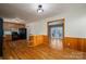 Open kitchen featuring wood cabinets, black appliances and hardwood floors at 9026 Longview Dr, Charlotte, NC 28214
