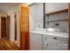 Efficient laundry area with appliances, shelving, and folding doors for organization and storage at 9026 Longview Dr, Charlotte, NC 28214