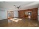 Open living room with hardwood floors, brick accents, and natural light at 9026 Longview Dr, Charlotte, NC 28214