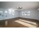 Spacious living room with hardwood floors, a ceiling fan, and multiple windows at 9026 Longview Dr, Charlotte, NC 28214
