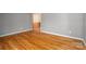 Living room with hardwood floors, gray walls, and view into other rooms of the home at 9026 Longview Dr, Charlotte, NC 28214