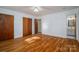 Spacious bedroom with hardwood floors, and access to the en-suite bathroom at 9026 Longview Dr, Charlotte, NC 28214