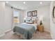 Comfortable bedroom featuring a window, stylish decor, and a cozy bed with decorative pillows at 912 Smithcliffs Trl, York, SC 29745