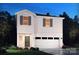 Inviting two-story home featuring white siding, brick accents, and an attached two-car garage at 912 Smithcliffs Trl, York, SC 29745