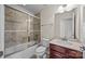 Bathroom featuring tiled shower, granite vanity, and modern lighting at 11142 Jc Murray Nw Dr, Concord, NC 28027