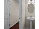 Clean half bath featuring a pedestal sink and modern lighting fixtures at 11142 Jc Murray Nw Dr, Concord, NC 28027