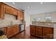 Modern kitchen boasts granite countertops, stainless steel appliances, and stylish wood cabinetry at 11142 Jc Murray Nw Dr, Concord, NC 28027