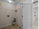 Functional laundry room equipped with shelving, washer/dryer hookups, and neutral flooring at 11142 Jc Murray Nw Dr, Concord, NC 28027