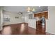 This open-concept living room and kitchen features hardwood floors and stainless steel appliances at 11142 Jc Murray Nw Dr, Concord, NC 28027