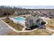 Community pool and clubhouse nestled between parking area and new townhomes in a well-maintained landscape at 11142 Jc Murray Nw Dr, Concord, NC 28027