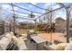 Relaxing backyard oasis featuring wicker seating, stylish pergola, elevated deck, and mature trees at 127 Wright Cir, Cherryville, NC 28021