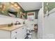 Charming bathroom featuring vanity with sink, decorative mirror, stylish fixtures, and tiled floors at 127 Wright Cir, Cherryville, NC 28021
