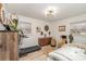 Bright bedroom with ample windows, laminate floors, stylish decor, and convenient exercise equipment at 127 Wright Cir, Cherryville, NC 28021