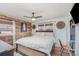 Cozy bedroom featuring a ceiling fan, wood accent wall, and comfortable queen-sized bed at 127 Wright Cir, Cherryville, NC 28021