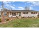 Charming single-story home with white painted brick, dark shutters, and a well-manicured front lawn at 127 Wright Cir, Cherryville, NC 28021