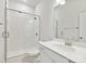 Bathroom featuring a tile shower with glass door and a single sink vanity at 13134 Macon Hall Dr, Mint Hill, NC 28227