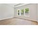 Bright bedroom featuring hardwood floors and large windows offering outdoor views at 13134 Macon Hall Dr, Mint Hill, NC 28227