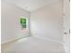 Bedroom with neutral carpet and a window view of the unfinished yard at 13134 Macon Hall Dr, Mint Hill, NC 28227