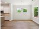 Open dining area with modern lighting, bright windows, and easy access to the kitchen at 13134 Macon Hall Dr, Mint Hill, NC 28227