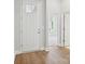 Inviting foyer with hardwood floors and a view into a naturally lit living space at 13134 Macon Hall Dr, Mint Hill, NC 28227