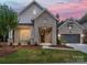 Charming brick home with a well-manicured lawn and inviting covered entryway at 13134 Macon Hall Dr, Mint Hill, NC 28227