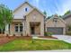Charming brick home with a well-manicured lawn and inviting covered entryway at 13134 Macon Hall Dr, Mint Hill, NC 28227