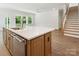 Kitchen island featuring stainless steel dishwasher, bar seating, and quartz countertop at 13134 Macon Hall Dr, Mint Hill, NC 28227