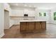 Bright kitchen boasts white cabinets, stainless appliances, and a central island with ample countertop space at 13134 Macon Hall Dr, Mint Hill, NC 28227