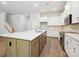 Open kitchen featuring a large island with seating, stainless steel appliances, and white cabinets at 13134 Macon Hall Dr, Mint Hill, NC 28227