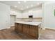 Bright kitchen boasts white cabinets, stainless appliances, and a central island with ample countertop space at 13134 Macon Hall Dr, Mint Hill, NC 28227
