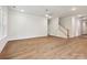 Open concept living room features wood-look floors, a staircase, and neutral paint at 13134 Macon Hall Dr, Mint Hill, NC 28227