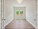Bright office space with double glass doors, hardwood floors, and views to the exterior at 13134 Macon Hall Dr, Mint Hill, NC 28227