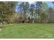 Expansive, level backyard with mature trees and a storage shed, enclosed by fencing at 132 Tuskarora Point Ln, Mooresville, NC 28117
