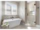 A luxurious bathroom features a soaking tub and frameless glass shower at 132 Tuskarora Point Ln, Mooresville, NC 28117