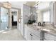 A bright bathroom boasts granite countertops, dual sinks and a walk-in shower at 132 Tuskarora Point Ln, Mooresville, NC 28117