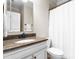 A well-lit bathroom offers white cabinets and granite countertops at 132 Tuskarora Point Ln, Mooresville, NC 28117