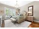 Serene bedroom features a tufted headboard and a door leading to a small private balcony at 132 Tuskarora Point Ln, Mooresville, NC 28117